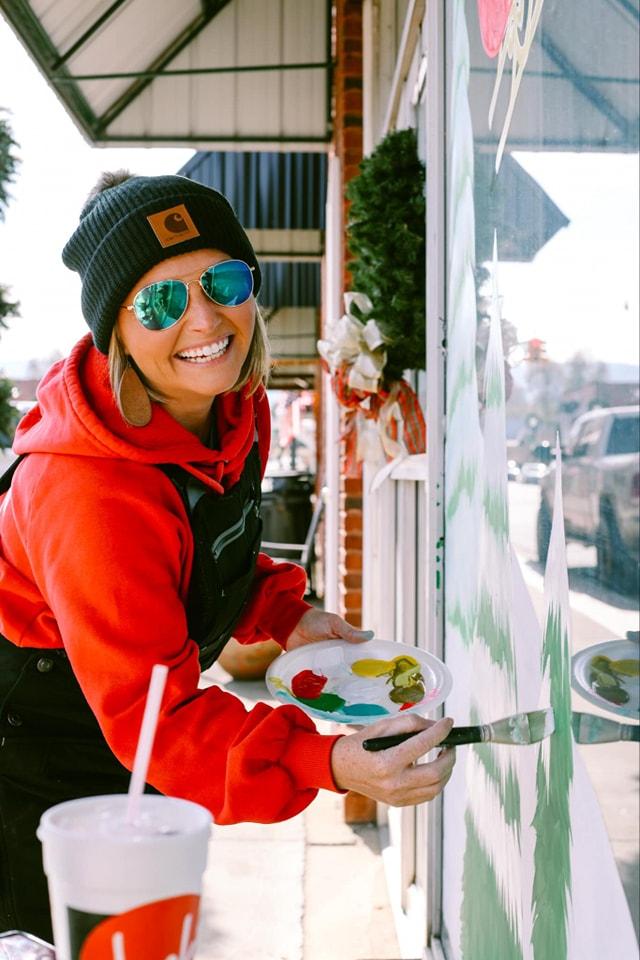 Tiffany Beal painting at a storefront