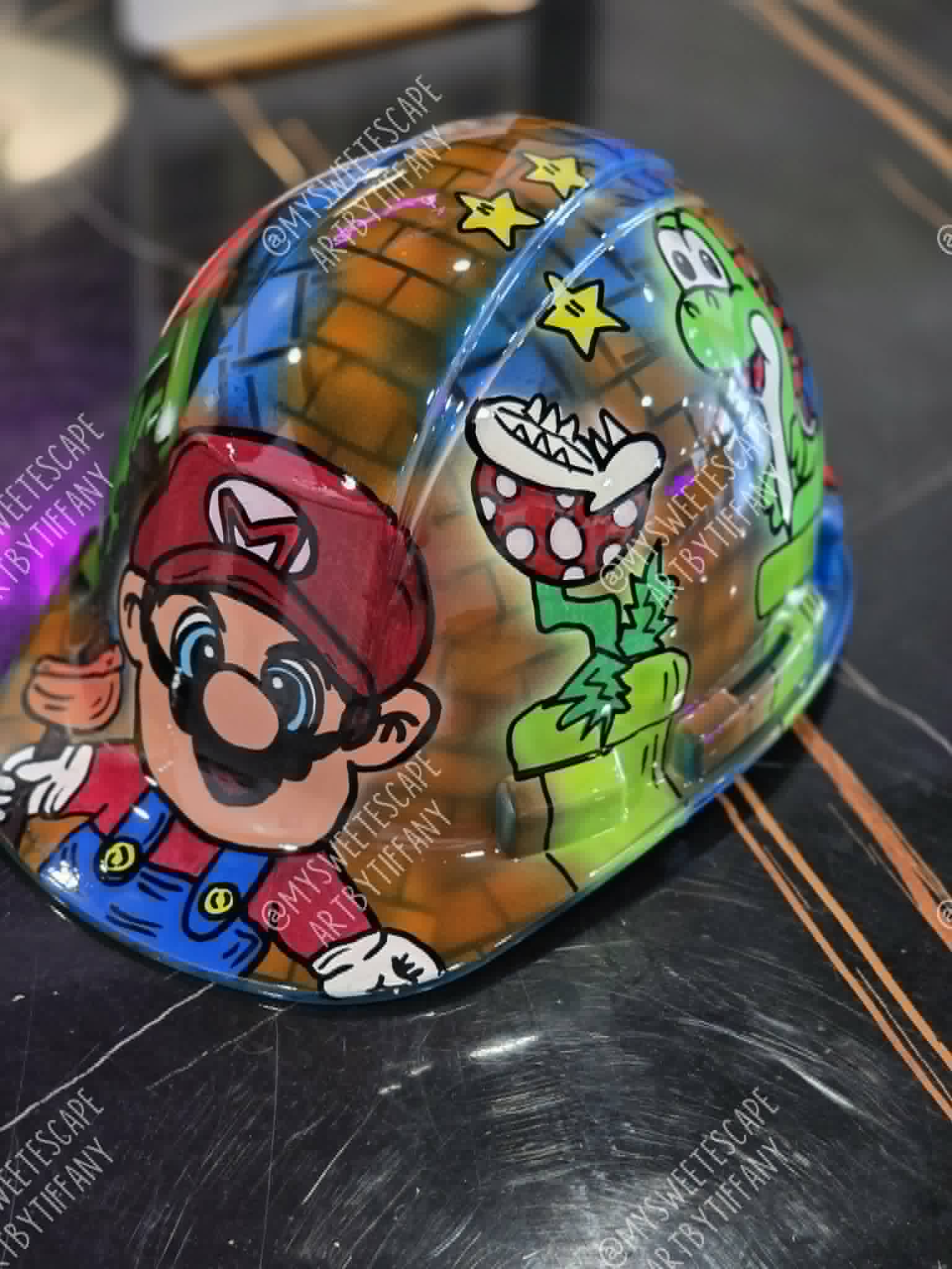 Custom hard hat painted with Super Mario characters and stars