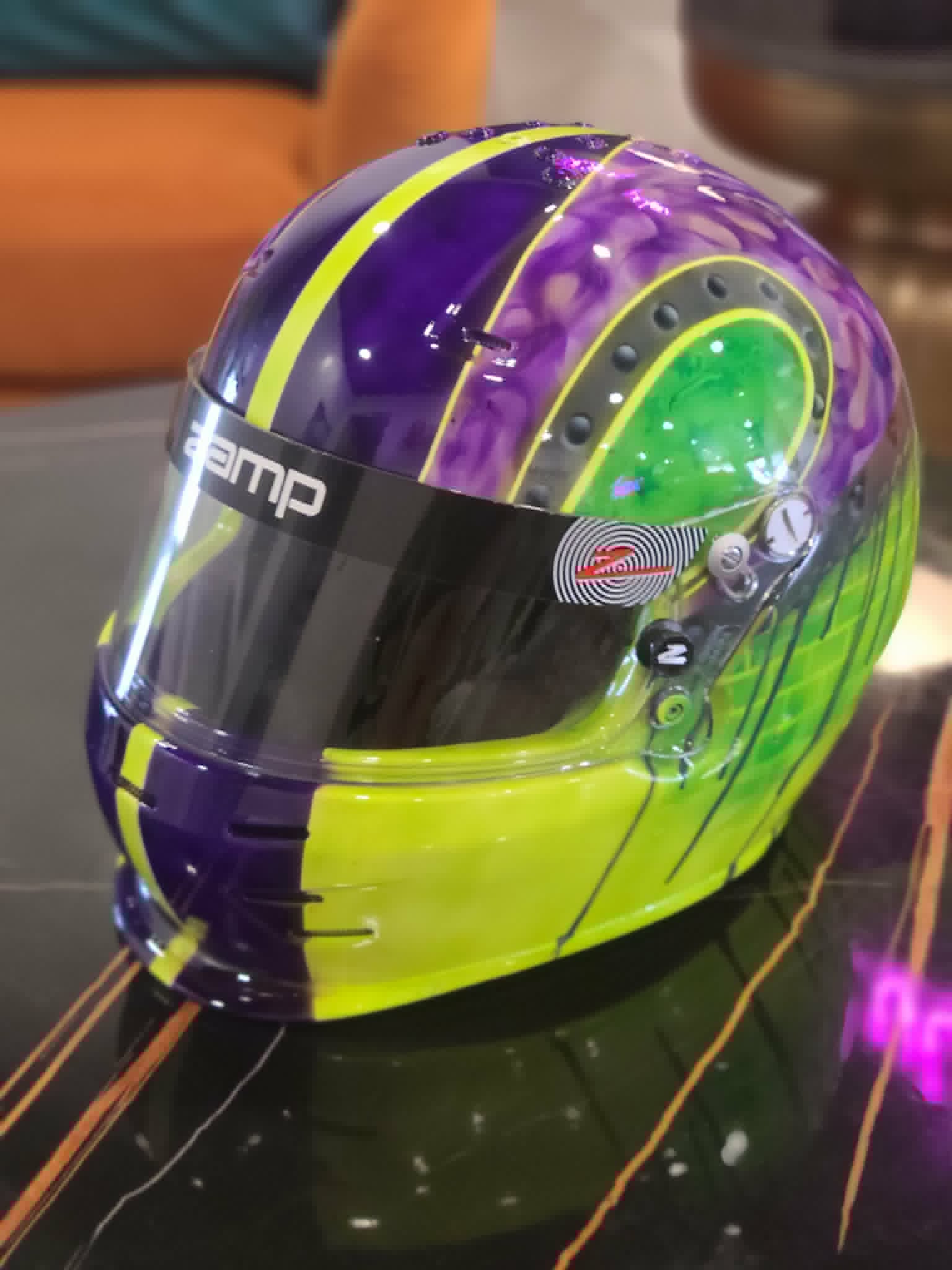 Custom racing helmet painted with neon green and purple lightning design