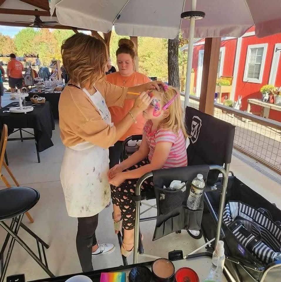 Painting a child's face at a community event
