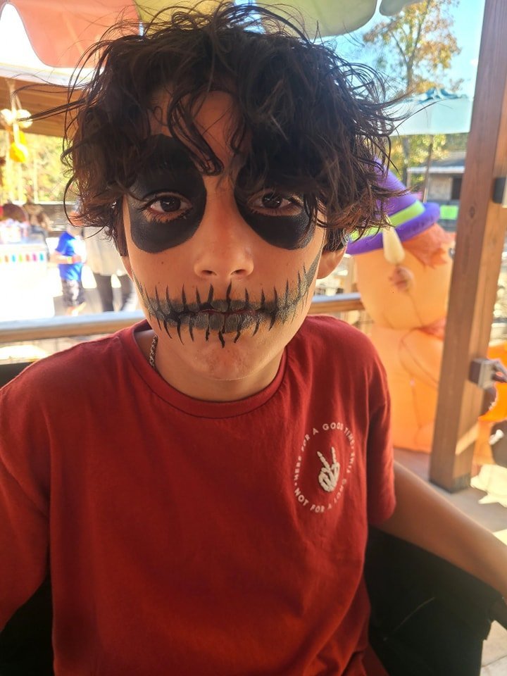 Spooky skeleton face paint on a young boy