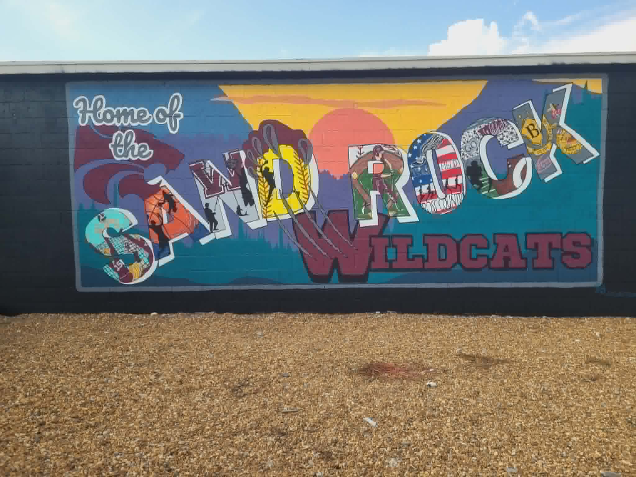 Sand Rock Wildcats mural on the side of a building