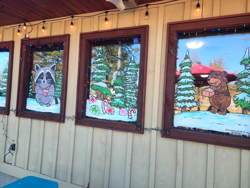 Christmas window painting with Santa and Rudolph at a storefront